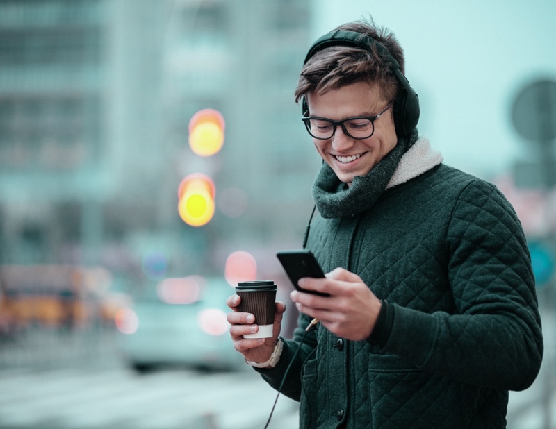 Young man uses smartphone